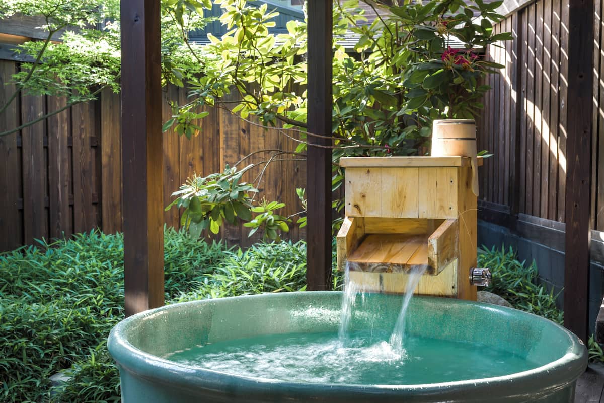 A wooden water feature with a wooden box and a large basin.