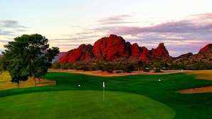 A golf course with a flagstick, trees, and red rock formations in the background. - HeatedPool, Upscale in OldTown Scottsdale (Scottsdale)