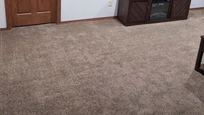 A room with a wooden door, a flat-screen TV mounted on the wall, and a wooden cabinet below it. - Cozy ranch style house in a quiet neighborhood (Sioux Falls)
