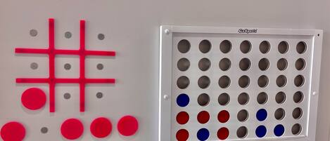 A wall with a pegboard and a storage unit with multiple compartments.