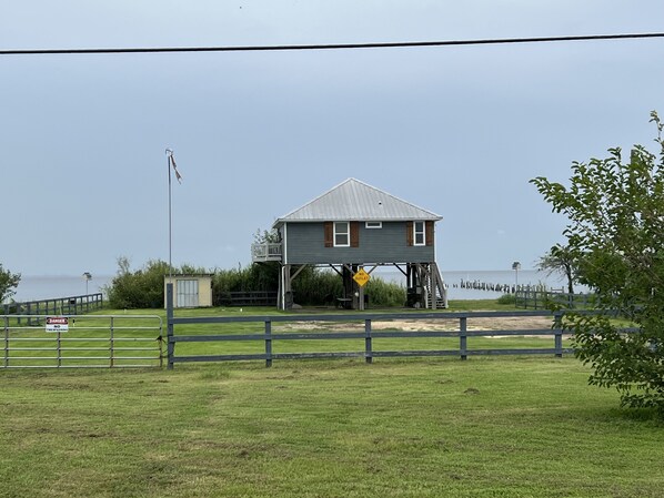 A two-story house with a balcony, a 'No Outlet' sign, and a 'Danger No Trespassing' sign.