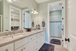 A bathroom with a double sink, a large mirror, and a walk-in shower. - Sleeps 18, Super Spacious, New Patio, Hot Tub, Best Location on the Lake (Silver Point)