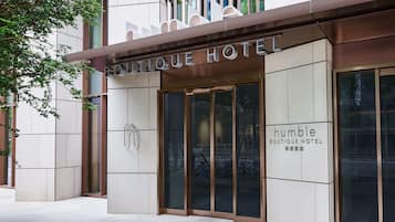 A boutique hotel entrance with a modern design, featuring large glass doors and a clear view of bicycles parked outside.