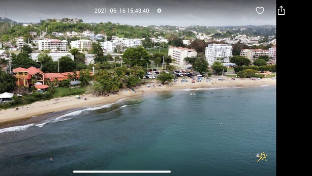 An aerial view of a coastal town with a beach, buildings, and greenery. - Lucor D- Eight House (Rincon PR)