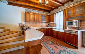Enjoy cooking in this well-equipped kitchen with a large island, sink, and modern appliances.