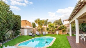 A backyard with a swimming pool, green lawn, and outdoor furniture. - L'Italienne by Interhome (Saint Cyr sur mer Les Lecques)