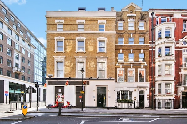 Traditional townhouses with classic architecture, featuring brick facades and white window frames.
