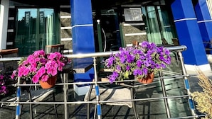 A hotel with a prominent sign reading "HOTEL IRIS" and flags on top. - Iris Hotel (Chisinau)