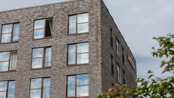 A multi-story building with a brick facade and multiple windows.
