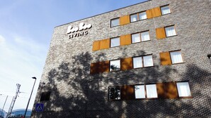 A building with a sign reading "Bee Bee Living." - Story Living Lidingö (Lidingo)