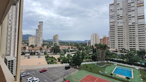 Zona residencial con edificios altos, estacionamiento y piscina.