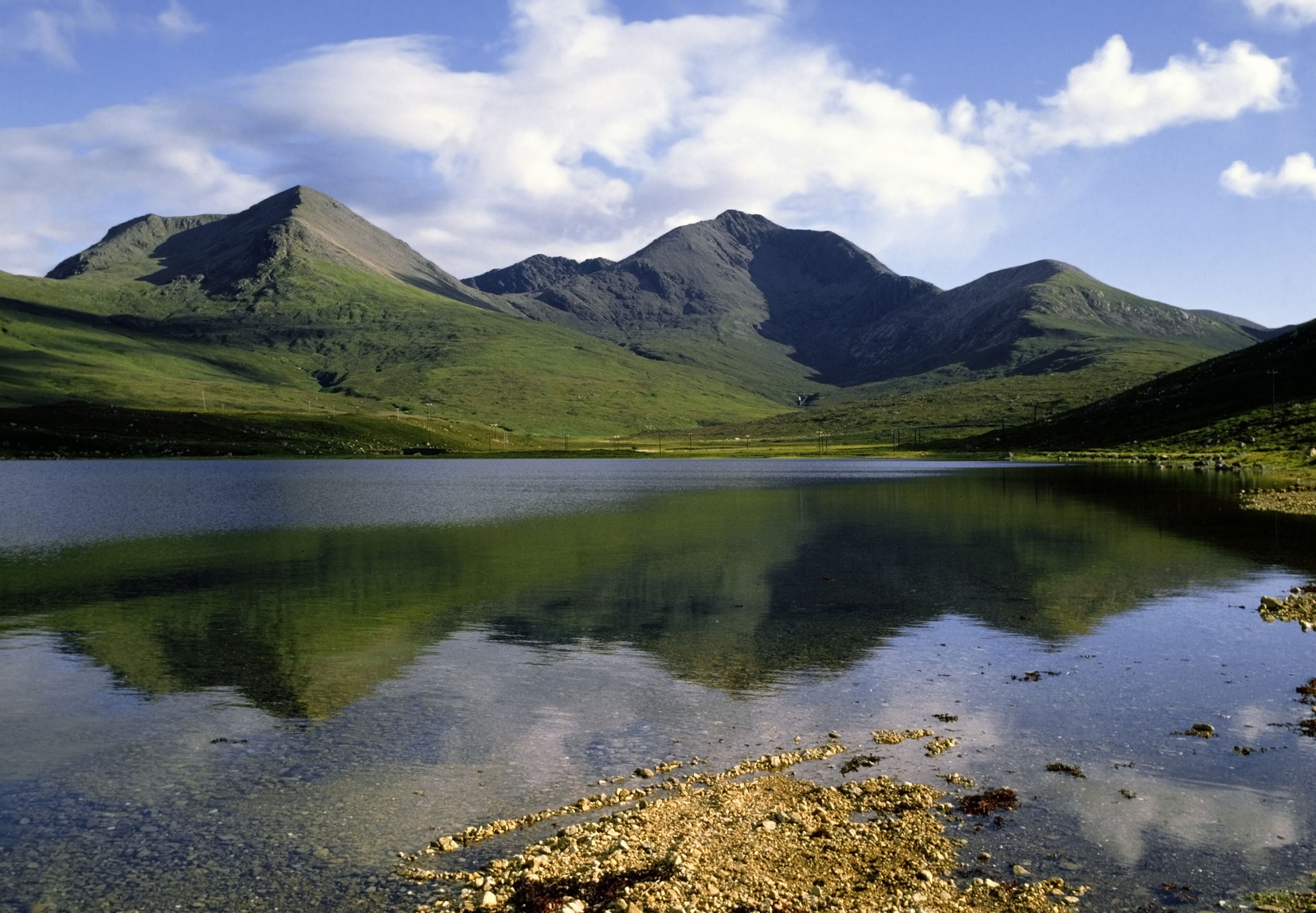 A tranquil lake with mountains in the background.
