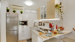 A modern kitchen with a built-in oven, microwave, and stainless steel refrigerator. - Apartment 'Esther Dream Bungallow' with Pool, Wi-Fi, A/C, Terrace & Garden (Mogán)
