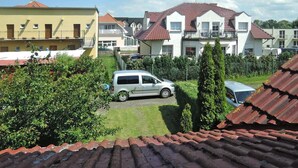 A residential area with multiple houses, a parked van, and a well-maintained lawn.