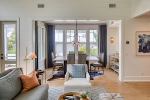 Relax in this stylish living area with a comfortable sofa, side table, and dining space.