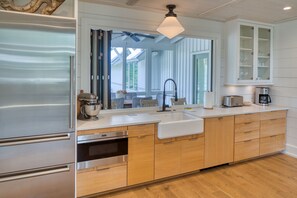 Enjoy cooking in this well-equipped kitchen with a refrigerator, oven, and large sink.