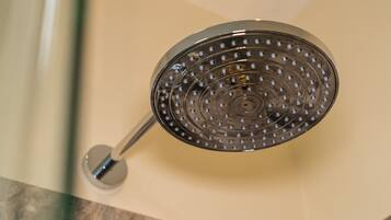 A showerhead with a circular design and multiple holes.