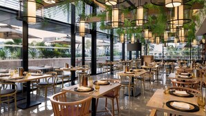 A spacious restaurant with high ceilings, large windows, and modern lighting fixtures. Tables are neatly arranged with chairs, and the floor is polished. - Tunis Marriott Hotel (Tunis)