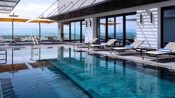 Outdoor pool, open 10:00 AM to 6:00 PM, pool umbrellas, pool loungers