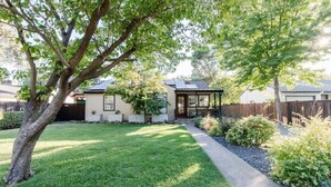 A residential property with a well-maintained lawn, a patio area, and a small garden. - Stargaze your evenings away in the private backyard Hot Tub. (Chico)