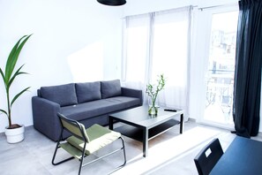 City Apartment | Living area | 30-inch TV with digital channels