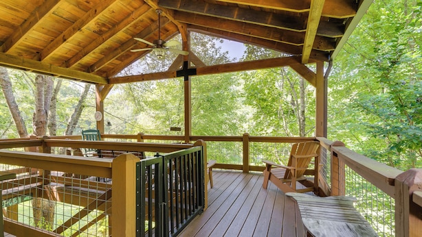 A wooden deck with a wooden railing, a bench, and a table. - Cozy Creekside Cabin w/ Fire Pit & Views! (Hayesville)