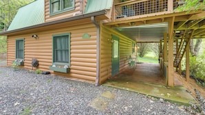 A log cabin with a covered porch and a small deck. - Cozy Creekside Cabin w/ Fire Pit & Views! (Hayesville)