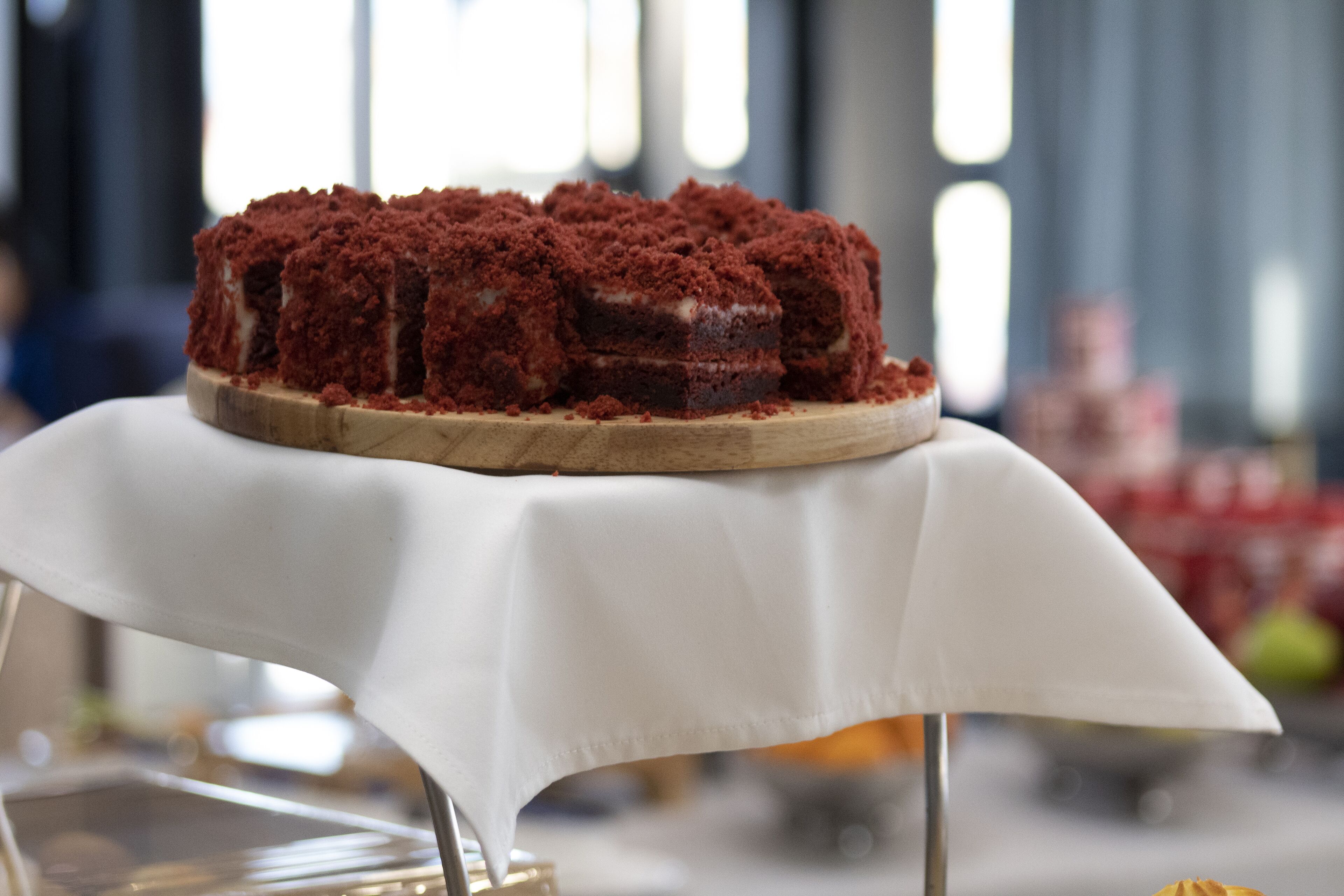 A dessert on a wooden board with a white cloth underneath.
