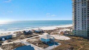 A beachfront property with a large building and several smaller structures. - Gorgeous 3 Bd/ 2+Ba home w/unobstructed views & easy beach access (Gulf Shores)