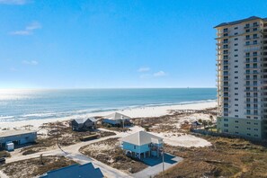 A beachfront property with a large building and several smaller structures. - Gorgeous 3 Bd/ 2+Ba home w/unobstructed views & easy beach access (Gulf Shores)