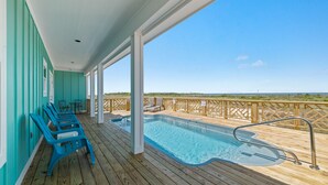 A wooden deck with a pool, lounge chairs, and a view of the beach. - Elevator & Private Pool- Luxury 6 Bd, 6 Ba Home. Close to Beach w/amazing views (Gulf Shores)