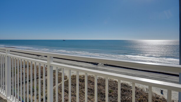 A balcony with a view of the ocean and beach. - Coastal Condo w/ Balcony in North Myrtle Beach! (North Myrtle Beach)