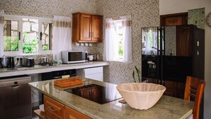 A kitchen with a microwave, toaster, and refrigerator. - south hill villa (Mahe)
