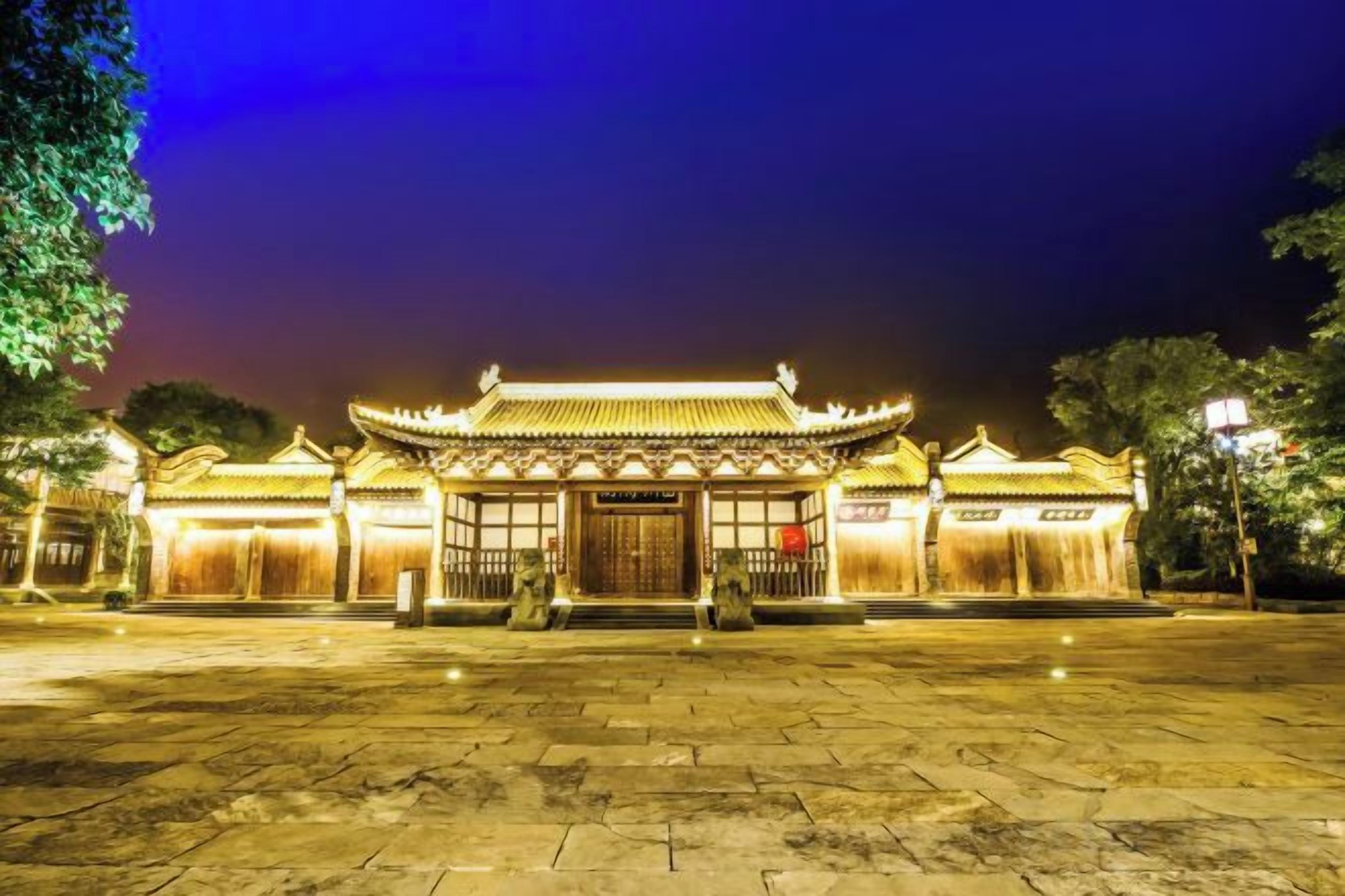 A traditional building with a tiled roof and a central entrance.