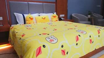 A bedroom with a bed, pillows, and a bedside table.