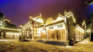 A traditional building with a tiled entrance and steps leading up to it.