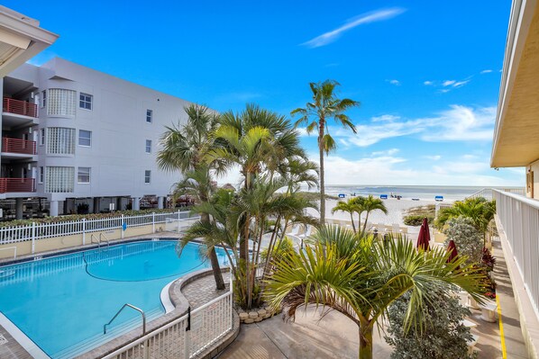 A heated pool - 🌴 Surf Song #237 — King Bed Comfort with Gulf Breezes & Walkable Charm (Madeira Beach)
