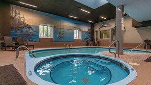 An indoor swimming pool with a mural on the wall, lounge chairs, and a tiled floor. - Mt-Orford ski 8.5Km. Walk to old Magog! Lake view w/pools, hot tub, sauna! Quiet (Magog)