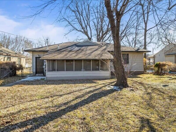 A single-story house with a front porch, a garage, and a yard with a tree. - Charming 3BR Home in Brookside |Near Gathering Plc (Tulsa)