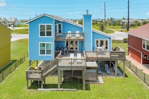 A two-story house with a balcony, a deck, and a garage.