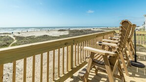 A wooden deck with chairs overlooking a beach. - Fresh Updates! Beachfront Escape w/ 2 Decks, Open Living Area - Steps from Beach (Galveston)