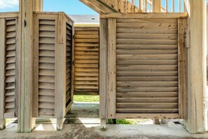 A wooden structure with a slatted design, possibly a part of a building or a deck.