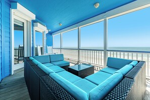 A covered outdoor seating area with a view of the ocean. - Gorgeous Beachfront Home w/ Pool Table, Wet Bar, 3 King Suites & More! (Galveston)