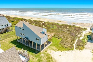 A two-story beachfront house with a balcony, a covered patio, and a view of the ocean. - Comfy Beachfront Home w/ Open Plan, Great Gulf View - Neighborhood Pool & Pier (Galveston)