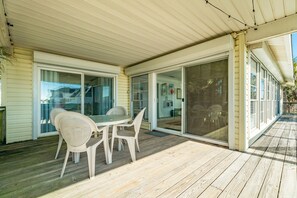 Enjoy a romantic meal for two on the deck with a table set amidst a serene outdoor space.
