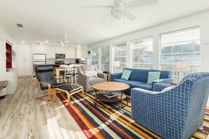 Relax in this stylish living area with a large sofa, coffee table, and unique chair.