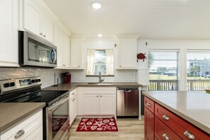 Enjoy cooking in this well-equipped kitchen with a microwave, oven, and dishwasher.