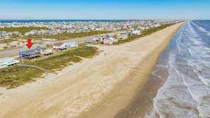 A coastal town with beachfront properties, a road running parallel to the beach, and a clear view of the ocean. - Updated Beachfront Home w/ Elevator+Ramp, 2 Primary Suites, Great Gulf Views (Galveston)