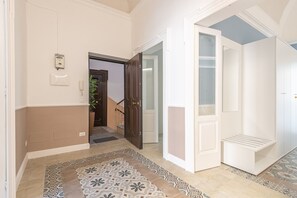 Leading to a cozy room with a white door and a convenient storage cabinet.