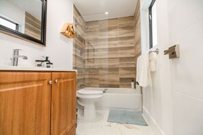 Bathtub, hair dryer, towels, soap